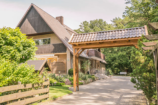 Einfahrt zum Landhaus Teuteberg in Bad Bevensen mit gepflastertem Weg zu den PKW-Stellplätzen der Ferienapartments